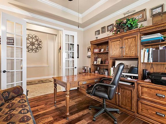OFF THE FOYER FRENCH DOORS AND FABULOUS WOOD FLOORING OPEN TO THIS FANTASTIC FLEX SPACE WITH UNLIMITED POTENTIAL. CURRENTLY SET AS A HOME OFFICE, THE ROOM COULD EASILY FUNCTION AS AN ADDITIONAL SITTING ROOM, CRAFTERS CORNER, PLAY ROOM, WORK OUT SPACE