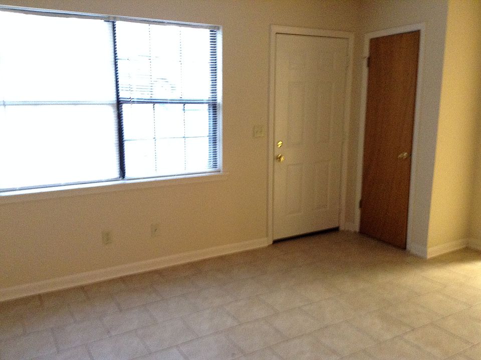 Pic of living room showing double windows, front door and coat closet.