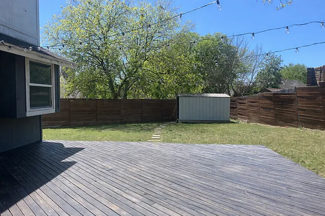 String lights over the deck and firepit area. Also pictured is the utility shed