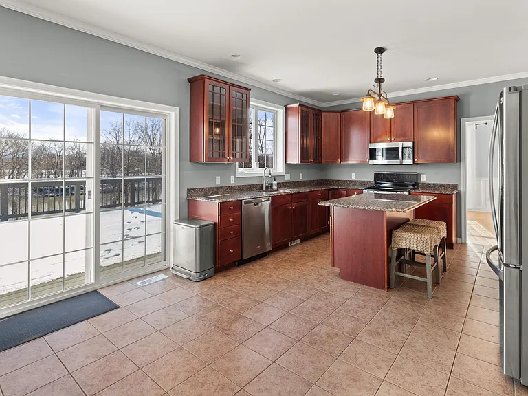 Kitchen. Looking towards sliding glass doors to a massive deck overlooking the Winooski River.