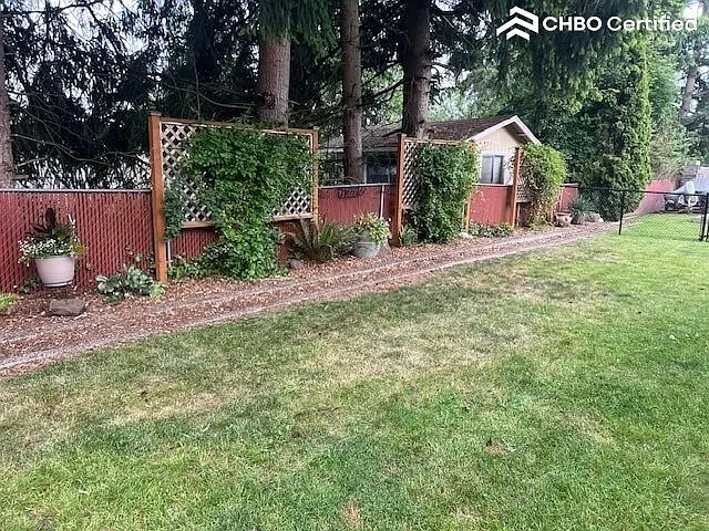 Spacious partially fenced backyard.