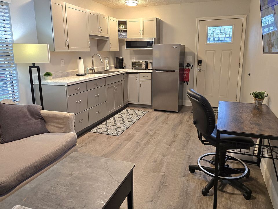 Private entrance to the suite with kitchenette and desk area.