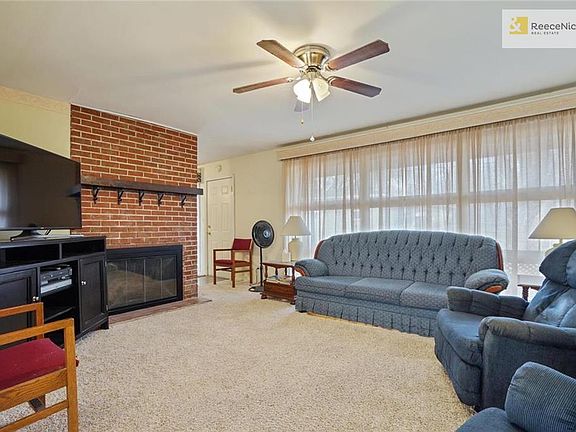 Huge Great room with brick Wood burning fireplace.  Wall of windows lets ton of light in!  Ceiling fan.