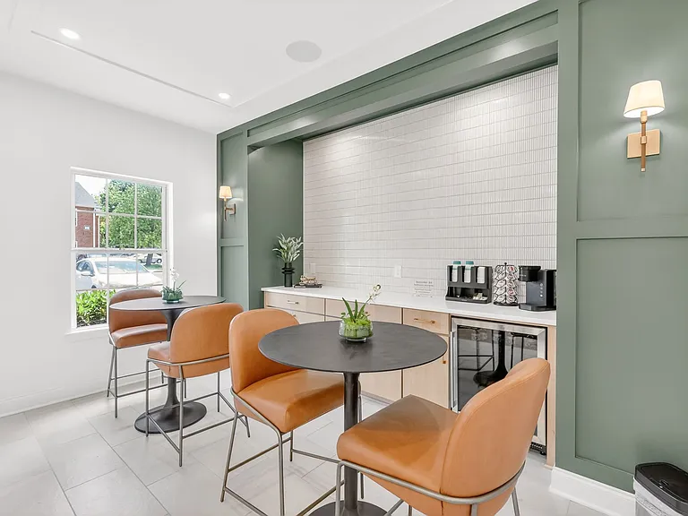 Resident coffee bar and sit-in lounge at Saddlebrook Apartments featuring complimentary coffee, comfortable seating, and modern community gathering spaces.