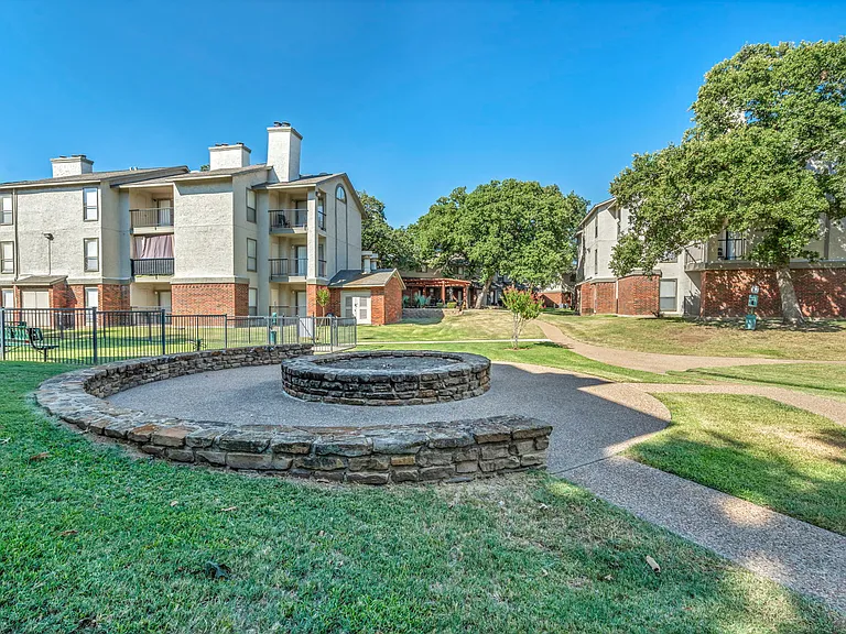 Wide open courtyard with mature trees.
