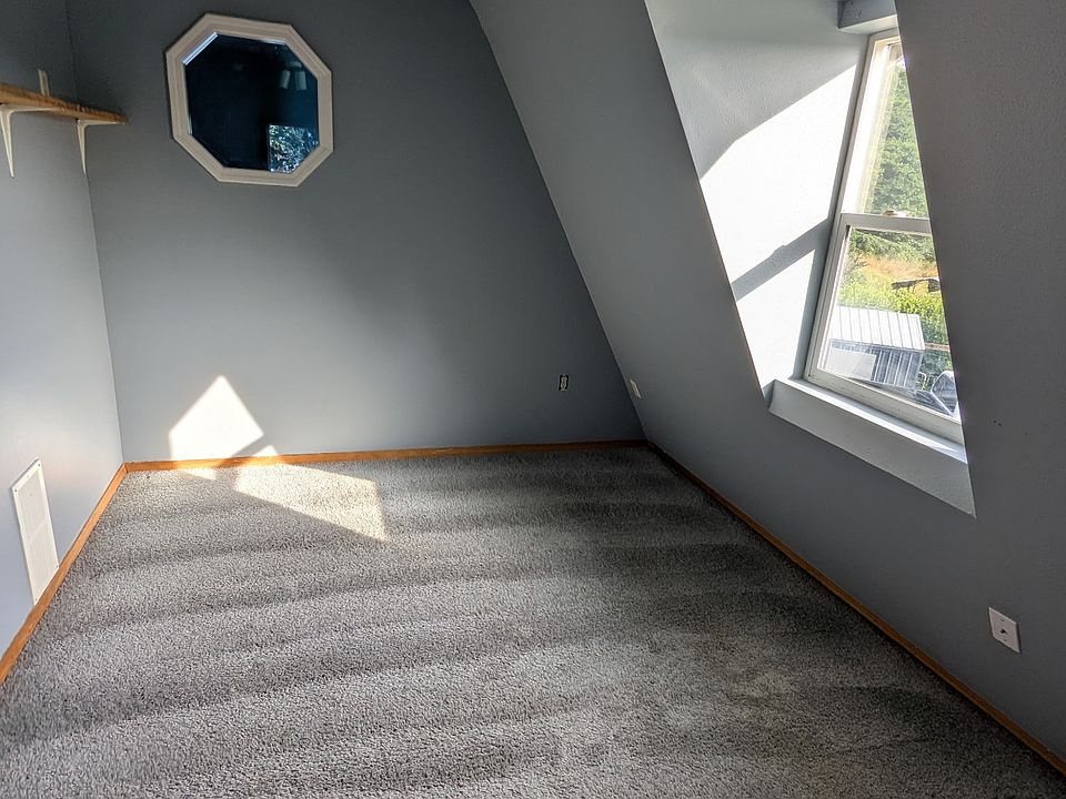 bedroom with a peek-a-boo window to living room