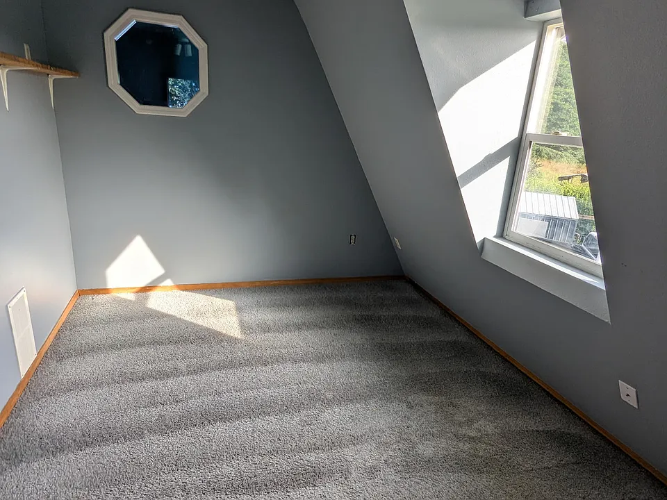 bedroom with a peek-a-boo window to living room