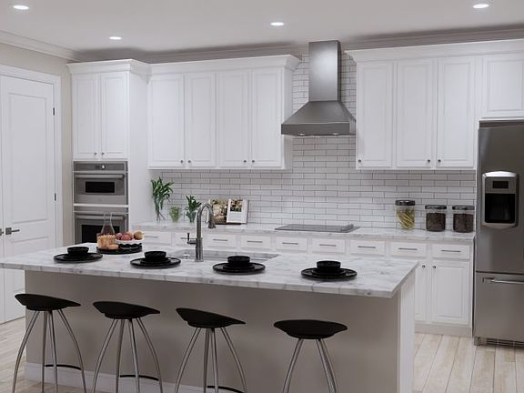 Stainless steel GE R appliances and undercabinet lights provide modern convenience in this stylish