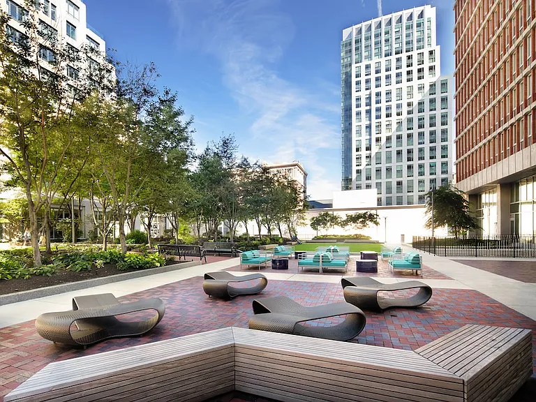 Outdoor courtyard with lounge seating and greenspace