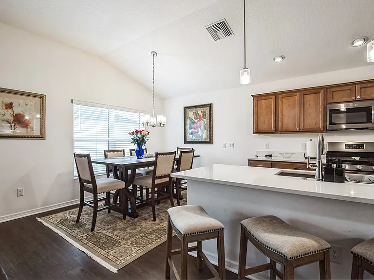 Dining Room Area and the Extra Large Island with Bar Sitting and the Kitchen Sink.