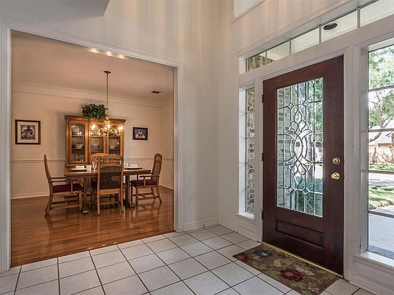 Dining room has wood flooring, crown and chair rail moldings.