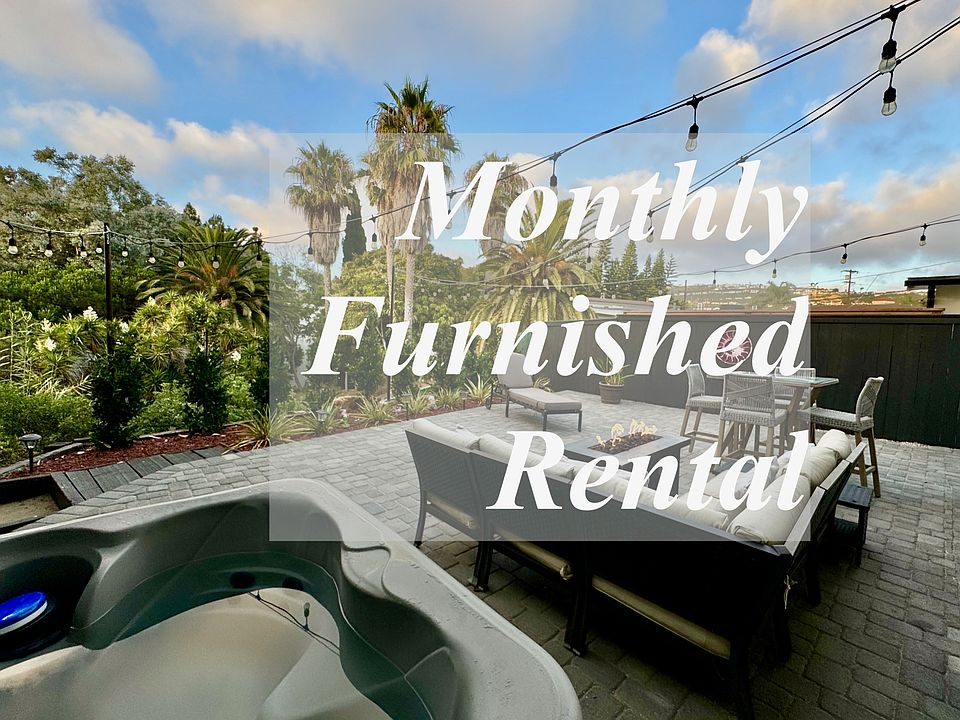 4 person hot tub, gas fire pit, outdoor seating, and outdoor dining table nestled in the canyon, with string lights and gorgeous views