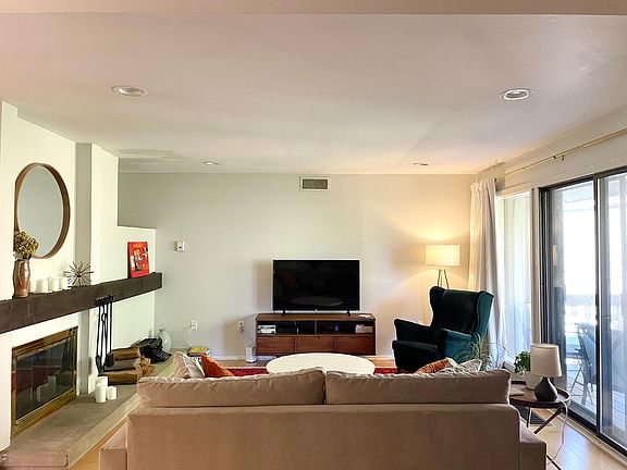 Living room with fireplace and sliders to balcony