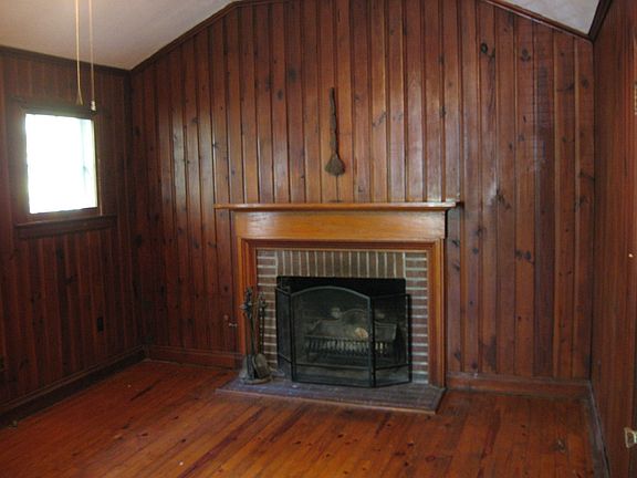 Heart pine paneled office/den/study with bath, fireplace and built-in bookcase