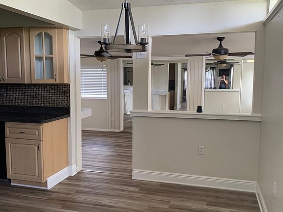 Right view from front door entry, space for dining room table and looking into bonus Florida room.