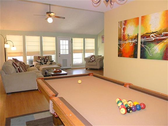 Wood laminate flooring highlights the den.