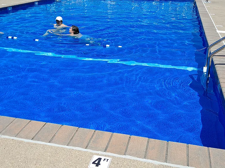 Great saltwater pool w/ lounges & tables w/ chairs & umbrellas.