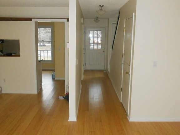 Living room looking back into kitchen and entry