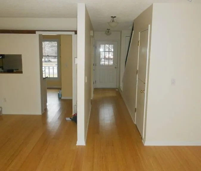 Living room looking back into kitchen and entry