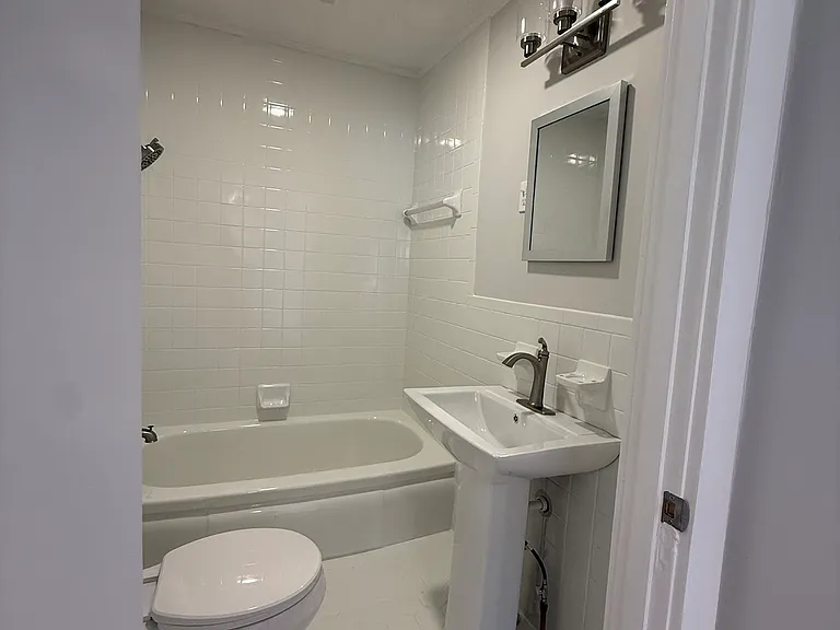 Renovated bathroom with all new fixtures, sink, and toilet.