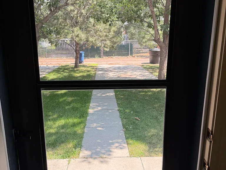Door to back yard, patio area, and off-street parking.