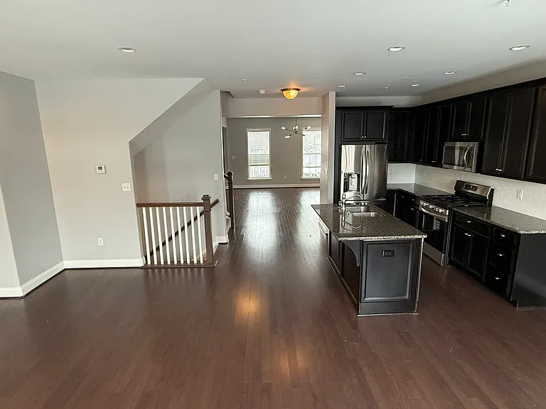 Diningroom looking back toward kitchen and livingroom with stairs on left