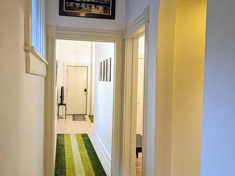 From the bedrooms (the arch on the right leads to the bathroom) looking back towards the living/kitchen area.