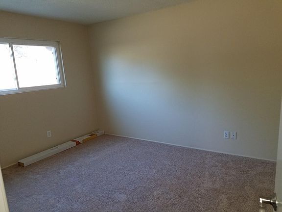 Master bedroom with new wood blinds going up