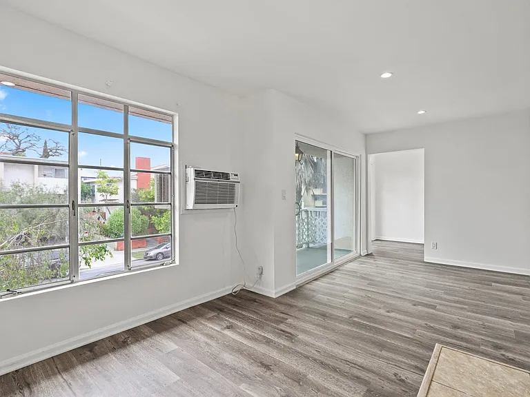 Living Room with Electric Fireplace, Recessed Lighting, Vinyl Flooring, and Patio