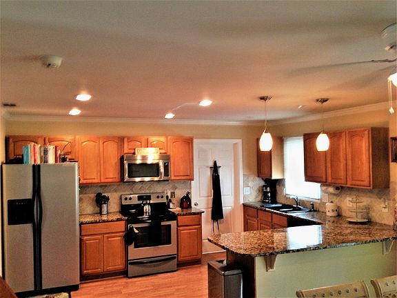 Fully equipped stainless steel kitchen with granite counter
