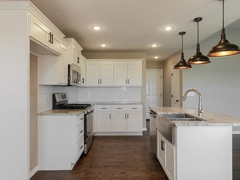 Stainless steel appliances and white cabinets