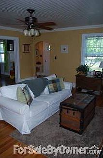 Living Room
						:
						Sunny living room with hardwood floors, tongue and groove ceiling, crown molding