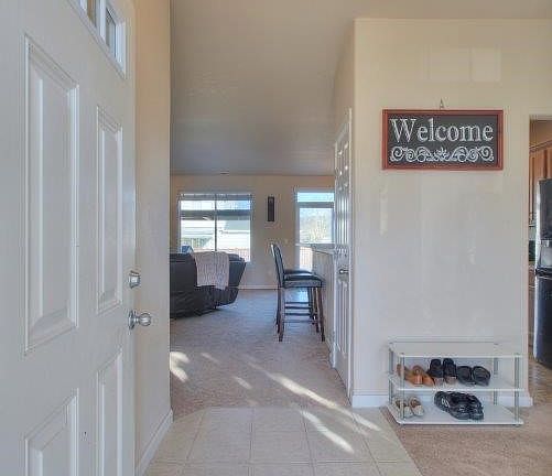 Spacious entry with a tile flooring. 
