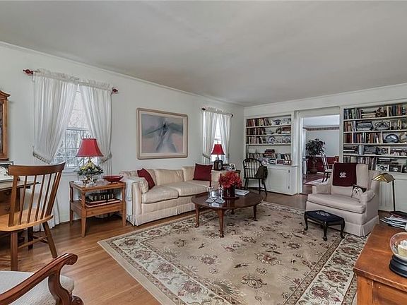 Spacious Living Room with Hardwood Flooring and Nice Built-In Bookcases