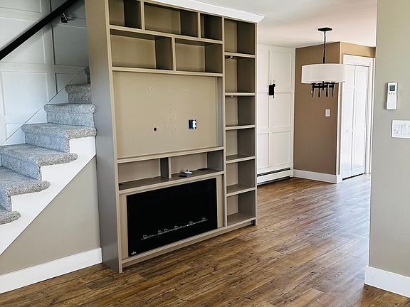 Living room with built in electric fireplace and entertainment center