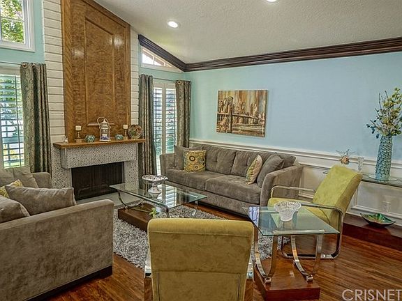 Formal Living off entry with updated floors and fireplace and shutters on all windows