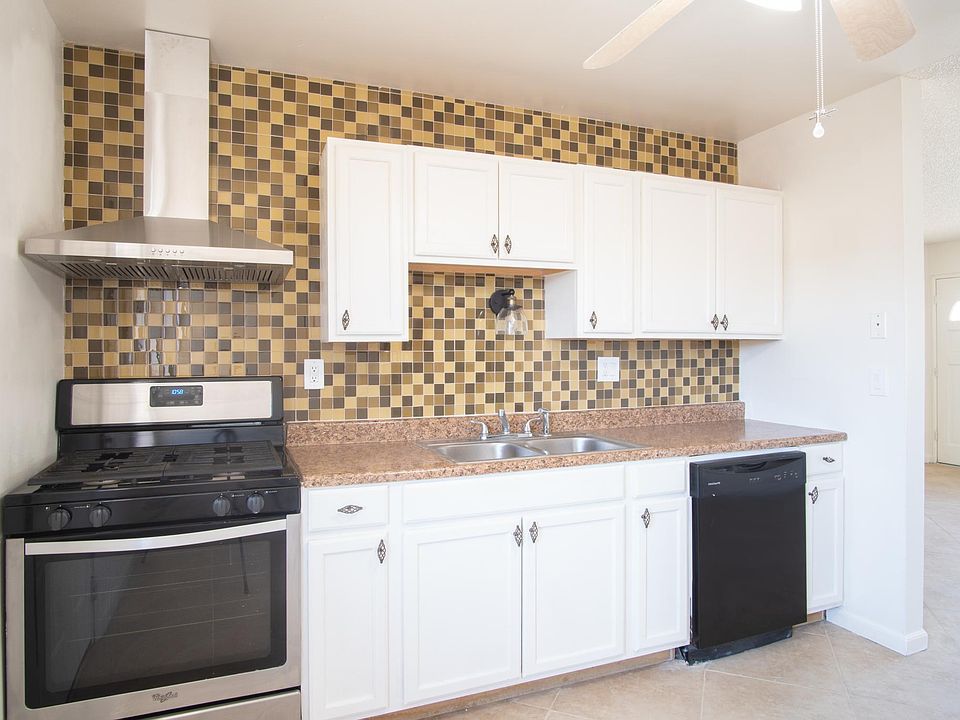 Ceiling high glass back splash with matching stainless appliances in an open floor plan!