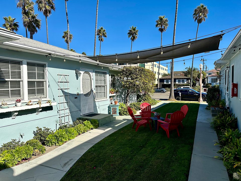 Front door with Bedroom windows on left and Living Room windows on right.