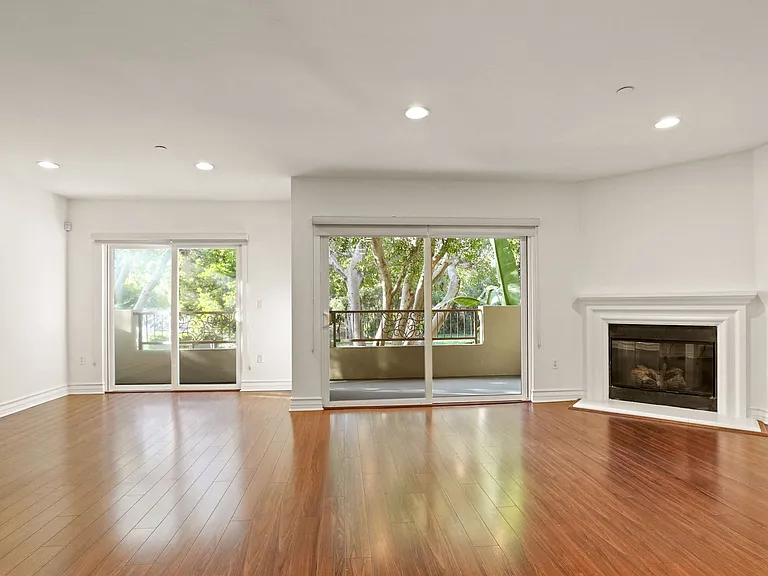 Spacious Living Room Area with an Electric Fireplace and Patio