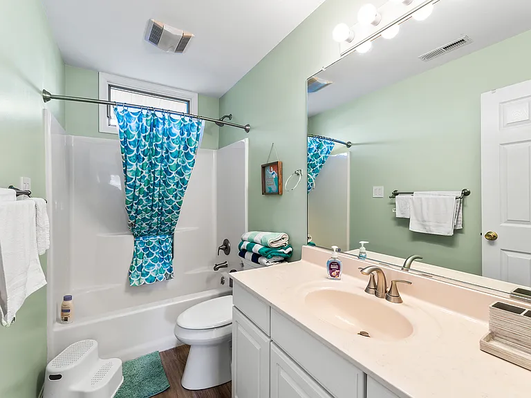 Full upstairs bathroom conveniently located near both upper-level bedrooms.