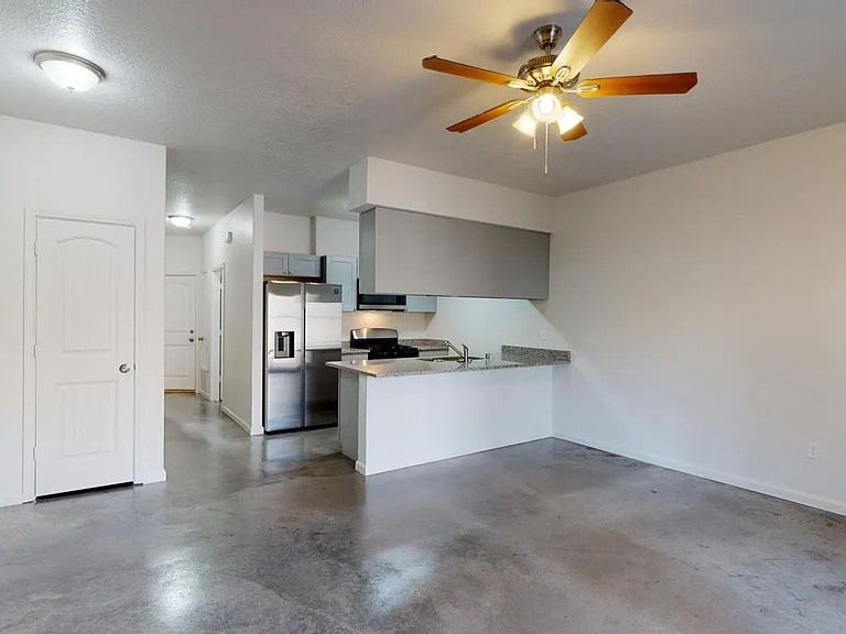 walk-in pantry under stairs with lighting and shelves