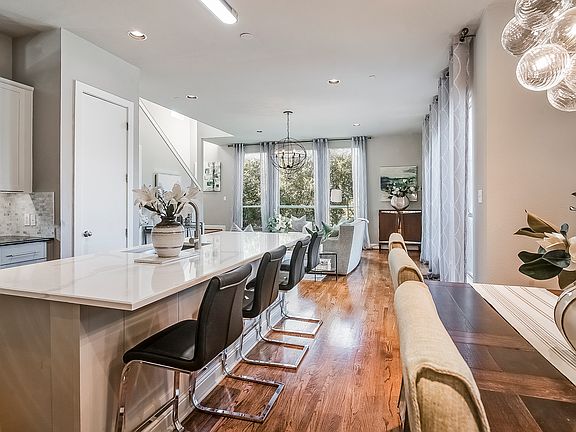 The second floor is flooded with light highlighting the beautiful timeless hard wood floors
