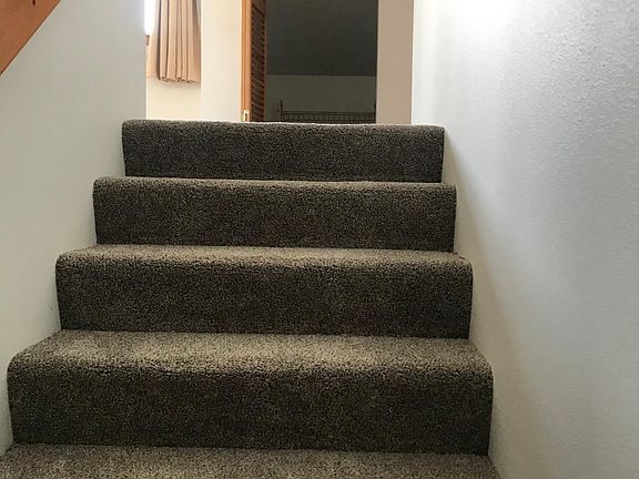 Stairs leading from the front door up to the unit.