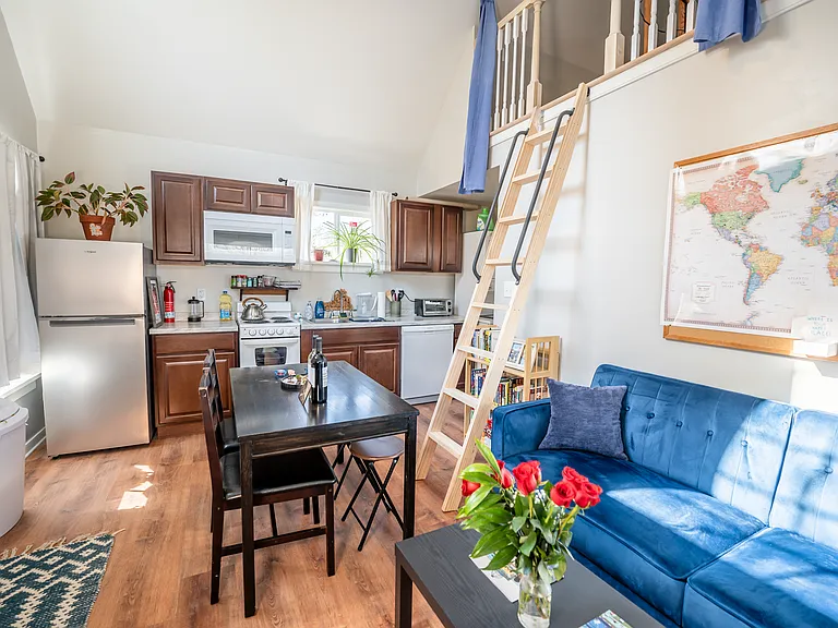 The open concept kitchen and living room boasts vaulted ceilings with tons of natural light