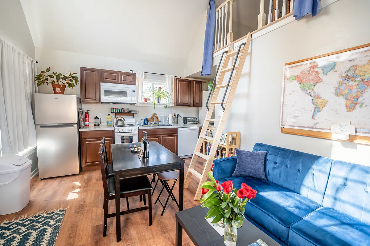 The open concept kitchen and living room boasts vaulted ceilings with tons of natural light - 1919 Wilmington Ave