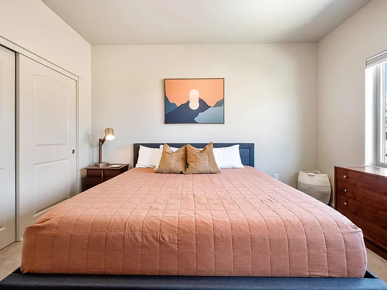 Primary bedroom with King Size Sapphire Silver Mattress. Standard closet and full dresser with side table.