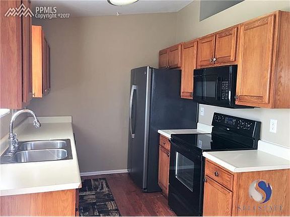 Kitchen w/ new refrigerator, sink and newer microwave.