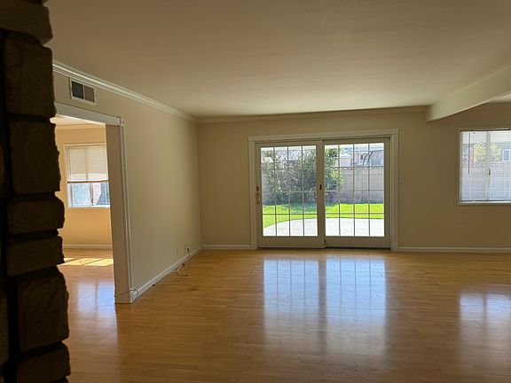 Living room with French doors leading to back patio and yard