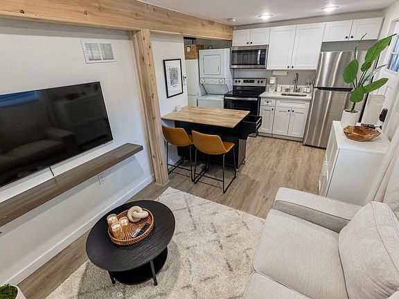 Living space & Kitchen with recessed lighting on dimmers.

50" TV