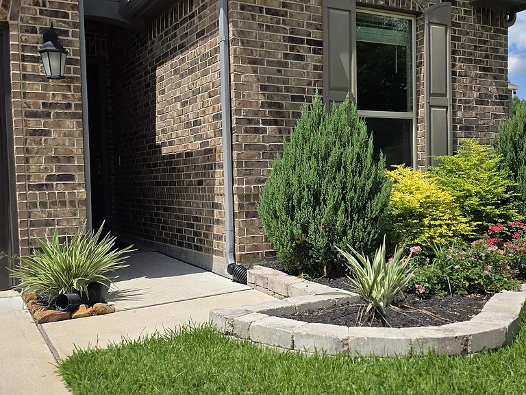Manicured front landscaping with automatic sprinkler system